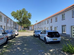 Doctor P. van Hoekstraat: zonnige dag auto's aan weerszijden straat geparkeerd